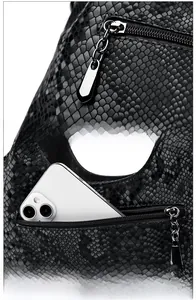 Detail of snake pattern leather bag featuring a silver zipper and rear phone pocket