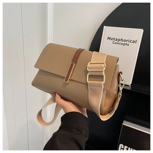Detail of khaki lychee grain leather bag with brown pull straps and gold hardware