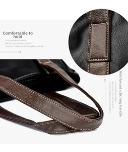 Detail of soft leather tote bag showing reinforced stitching and brown contrast handles