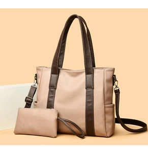 Detail of soft leather tote and matching pouch set with adjustable dark brown straps