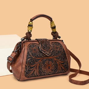 Vintage brown embossed floral handbag with wooden handle and crossbody strap detail
