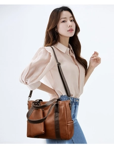 Detail of soft brown leather tote bag with matching coin purse and adjustable strap