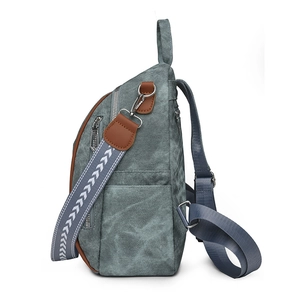 Vintage wash canvas backpack with faux leather trim and geometric patterned shoulder strap