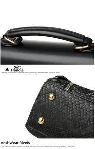 Detail of soft leather handle and anti-wear gold metal studs on the bottom of black bag