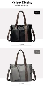 Close-up of black and grey large leather tote bags with contrasting shoulder straps