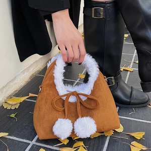Retro brown suede bucket bag with white faux fur trim and decorative pom-poms