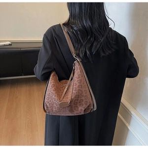 Model wearing a large leopard print suede hobo bag for casual daily outfit styling