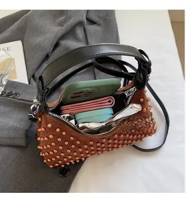 Interior view of brown beaded punk shoulder bag showing spacious storage for essentials