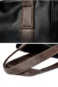 Close-up of contrast stitching and padded handle on a black leather tote bag