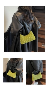 Detailed view of lime green shoulder bag with 3D beaded texture and black leather strap