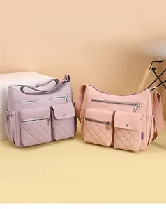 Detailed view of nylon crossbody bag with multi-pocket design and quilted texture