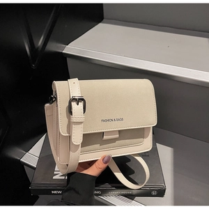 Dettaglio borsa beige in pelle con patchwork in camoscio e cinturino con fibbia