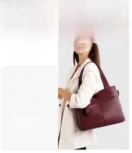 Detail of the soft pebble grain leather texture on this large burgundy tote bag for women