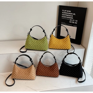 Quilted pearl hobo bags in five colors displayed on marble steps with detachable straps