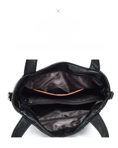 Detailed view of large capacity black leather tote interior with multiple compartments