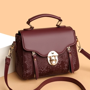 Retro burgundy snakeskin embossed crossbody bag with gold hardware and top handle
