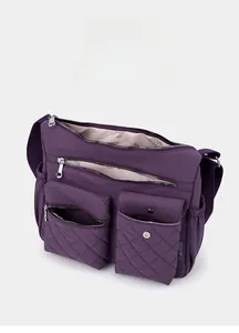 Detailed view of the purple nylon crossbody bag interior with multi-pocket storage layout