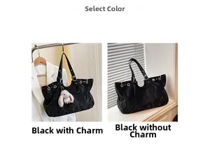 Detail of large black tote bag with unique pleated texture and metal eyelets decoration