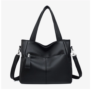 Close-up of black lychee grain texture on a large capacity leather tote bag with strap