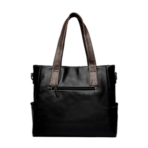Vintage black leather tote bag with brown handles and white stitching details
