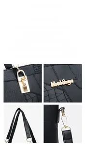 Close-up of golden hardware and crocodile pattern texture on black shoulder bag