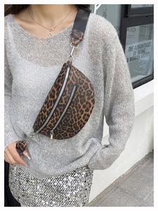 Detail einer Crossbody-Brusttasche mit Leopardenmuster, Doppelreißverschluss und Gurt