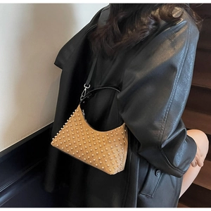 Detail of khaki crescent shoulder bag with pearl embellishments and thin black strap