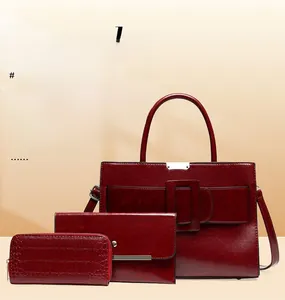 Detailed view of the dark red three-piece handbag set featuring glossy faux leather texture