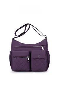 Detail view of large purple nylon crossbody bag with multiple zip pockets and quilting