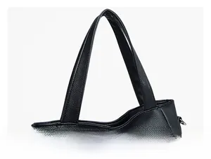 Detail view of black pebble leather tote bag with sturdy handles and precise stitching