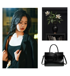 Detail of black tote bag with large square buckle and round handle for women