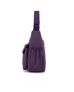 Side view of purple nylon crossbody bag showing elastic side pocket and diamond quilting detail