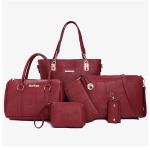 Detail of red six-piece bag set with luxury crocodile texture and gold hardware