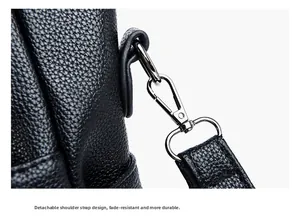Detail of silver metal lobster clasp and detachable strap on black lychee pattern leather