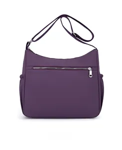 Back view of purple nylon crossbody bag showing horizontal zipper pocket and side pouches