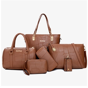 Brown crocodile embossed leather six-piece bag set with golden hardware on white background