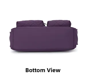 Detail view showing the flat bottom structure and quilted nylon pockets of the purple bag