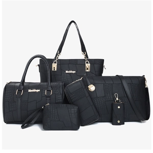 Detail view of 6-piece black handbag set with crocodile pattern and gold hardware