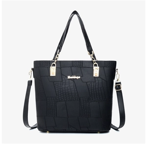 Close-up of black PU leather tote with crocodile texture, gold chains and metal logo