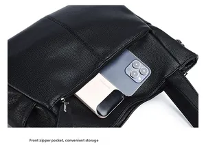 Close-up of black lychee grain leather bag featuring a front zipper pocket for storage