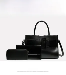 Detailed view of 3-piece black handbag set featuring polished faux leather and buckle