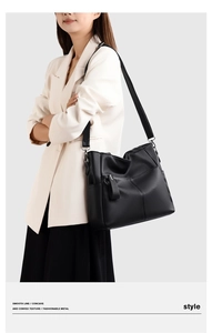 Detail of black large capacity shoulder bag with lychee pattern and metal zipper pocket