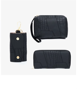 Three-piece black crocodile embossed leather set including clutch, wallet and key pouch