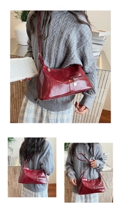 Close-up of retro wine red wrinkled texture underarm bag with metal zipper detail