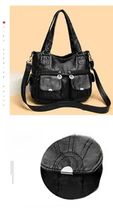 Close-up of black washed leather motorcycle bag with silver hardware and pockets