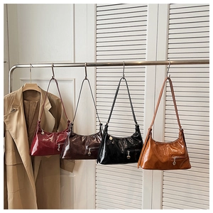 Hobo bags in burgundy, coffee, black, and caramel patent leather shown hanging