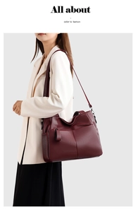 Burgundy soft leather tote bag with multi-pocket design shown on model for size and style