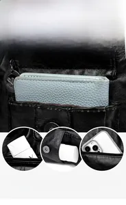 Macro view of multi-compartment interior and front magnetic pocket in black leather tote