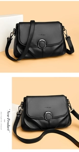 Detail view of black lychee grain leather bag featuring silver round metal buckle and logo