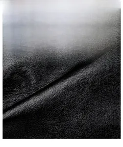Detailed macro view of high-quality black faux leather texture with soft pebbled grain